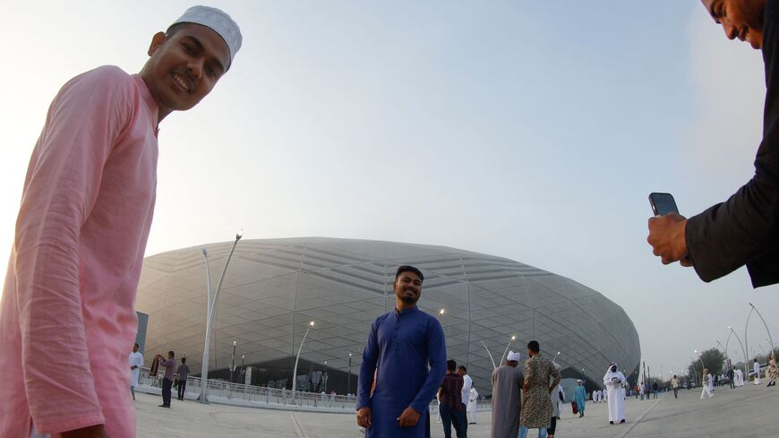 Muslim worshippers take pictures of each other after attending the Eid al-Adha morning prayers at Doha's Education City Stadium, which hosted matches during Qatar's 2022 FIFA World Cup, on the first day of the Muslim holiday on June 28, 2023. Eid al-Adha, or Feast of Sacrifice, marks the end of the hajj pilgrimage to Mecca. (Photo by KARIM JAAFAR / AFP) (Photo by KARIM JAAFAR/AFP via Getty Images)