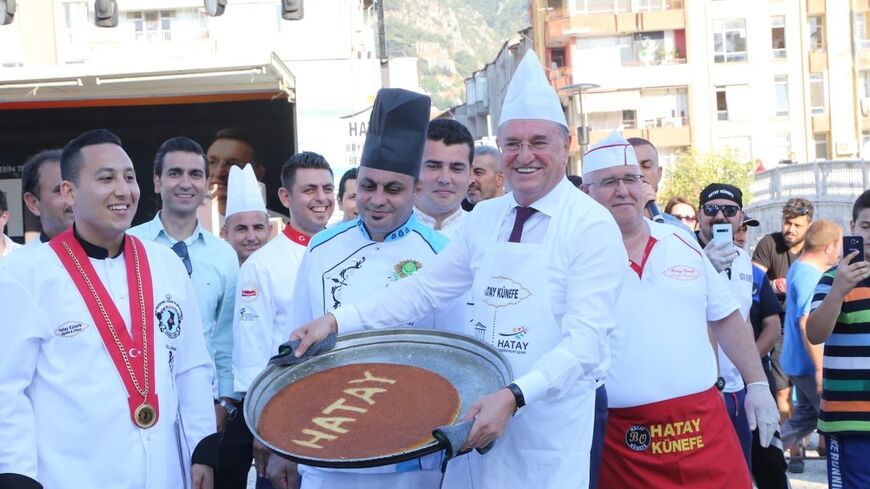 A chef holds a platter of kanafe during Hatay kanafe festival, July 23, 2019.